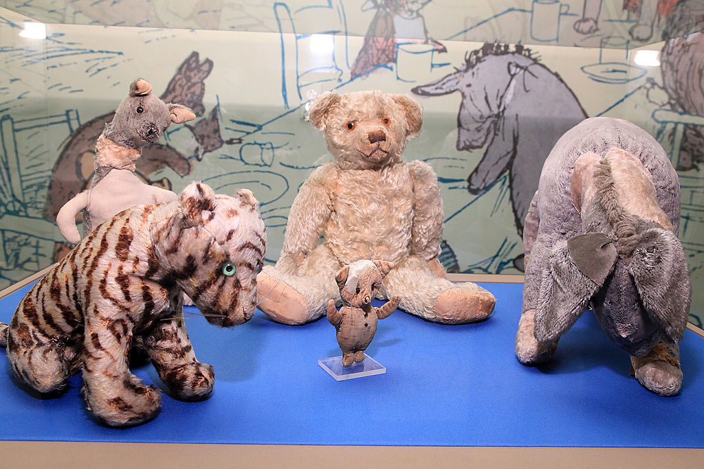 Vintage stuffed toys including a tiger, bear, and elephant on display