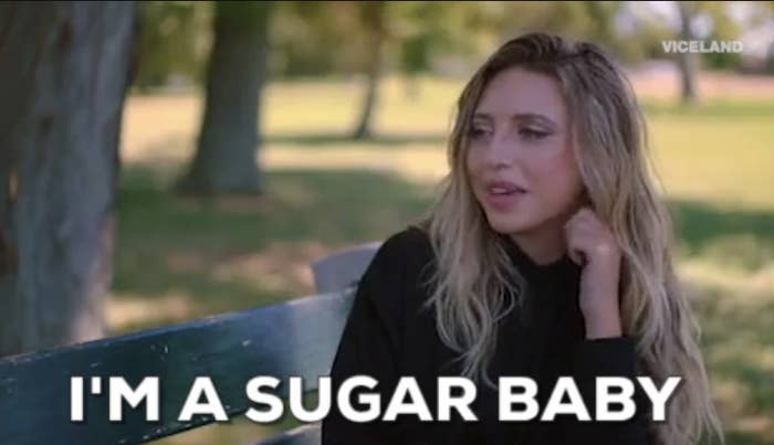 Woman sitting on a park bench in &quot;Slutever&quot; saying: &quot;I&#x27;m a sugar baby&quot;