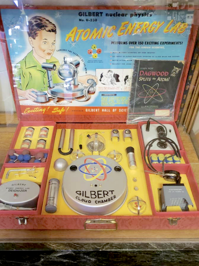 Vintage Gilbert Atomic Energy Lab set with various scientific equipment and experiment guides displayed