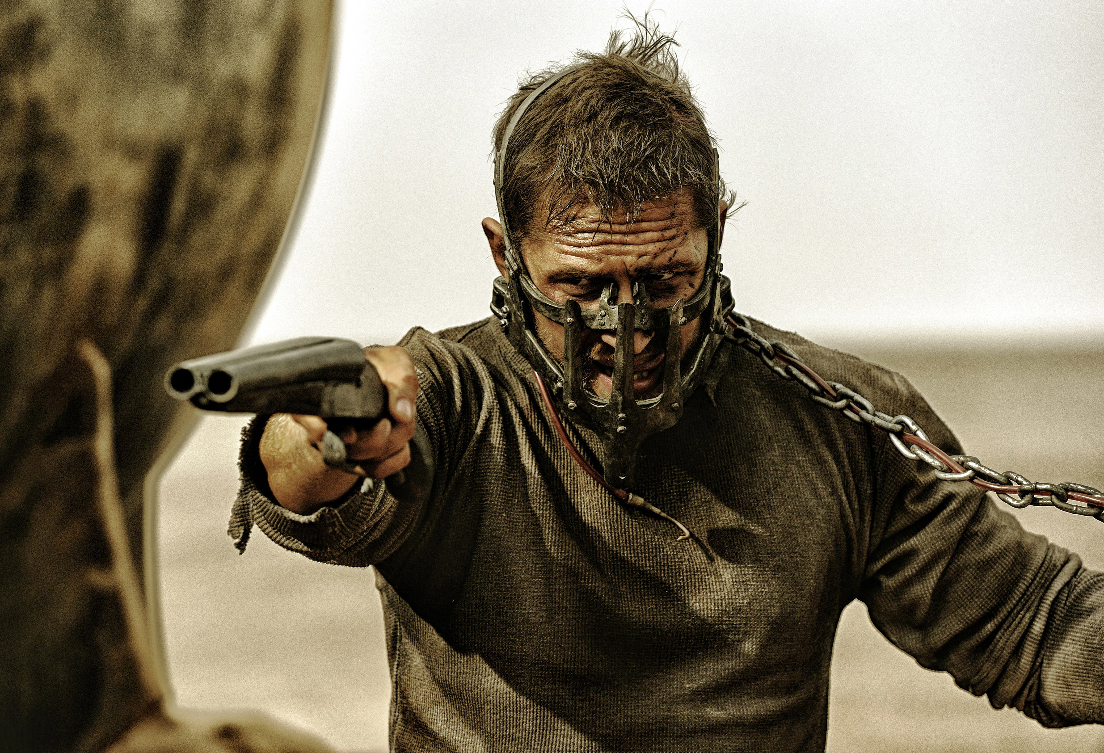 tom hardy with muzzle on pointing a gun