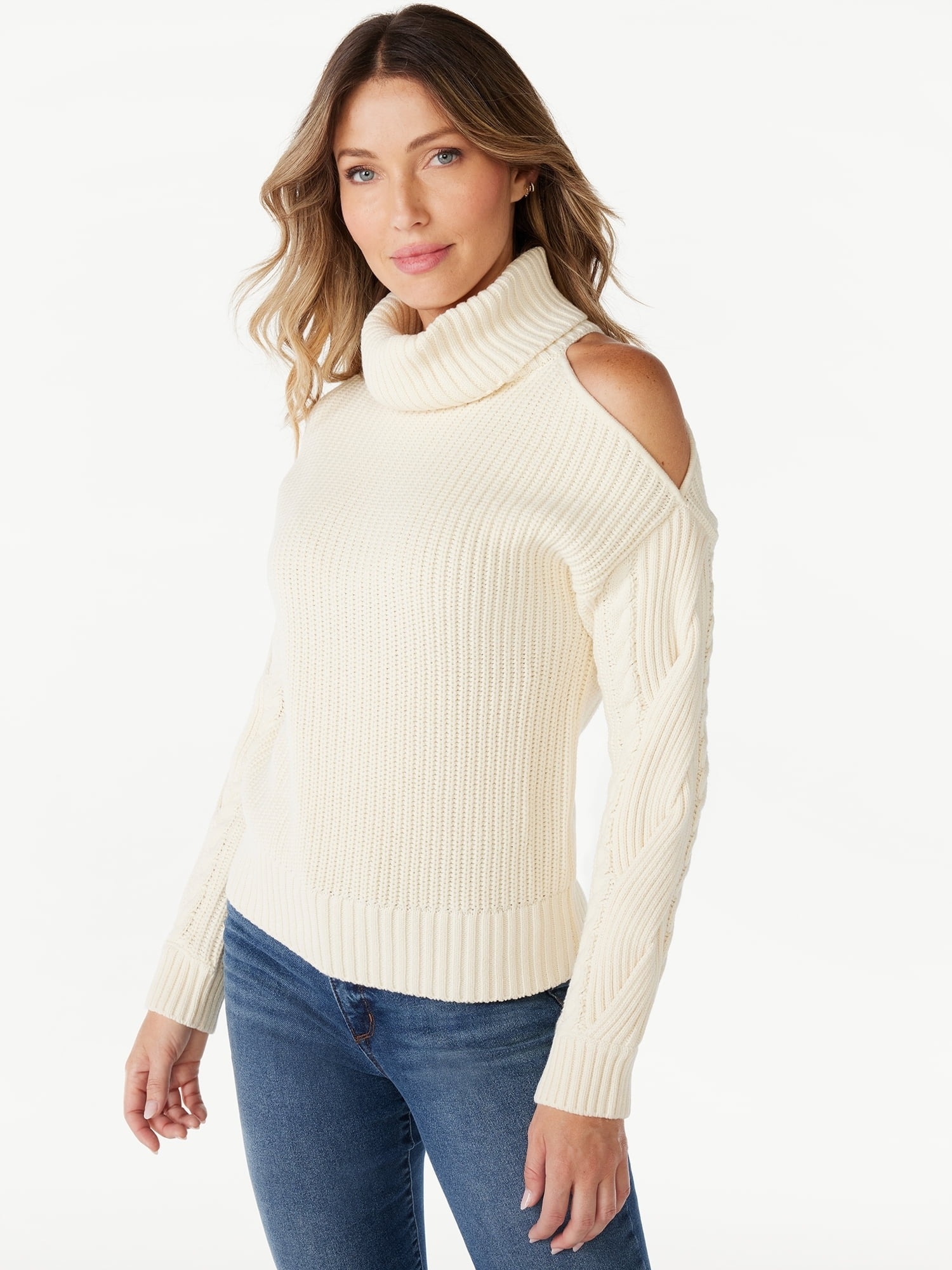 a model in a cream turtleneck sweater with shoulder cutout