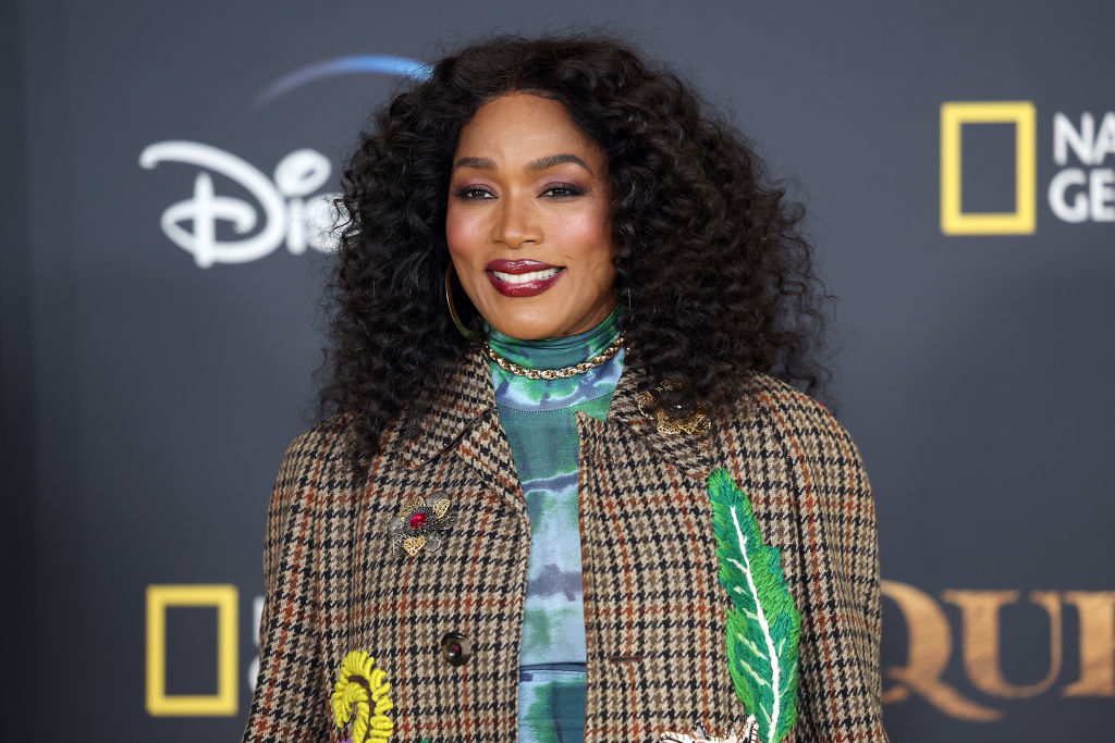 Angela Bassett in a patterned blazer with her long hair curled