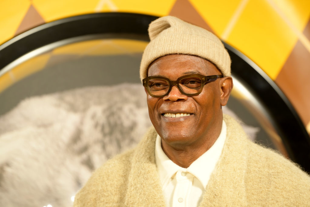 Samuel L. Jackson wearing a beanie and glasses, with a sweater over a polo shirt