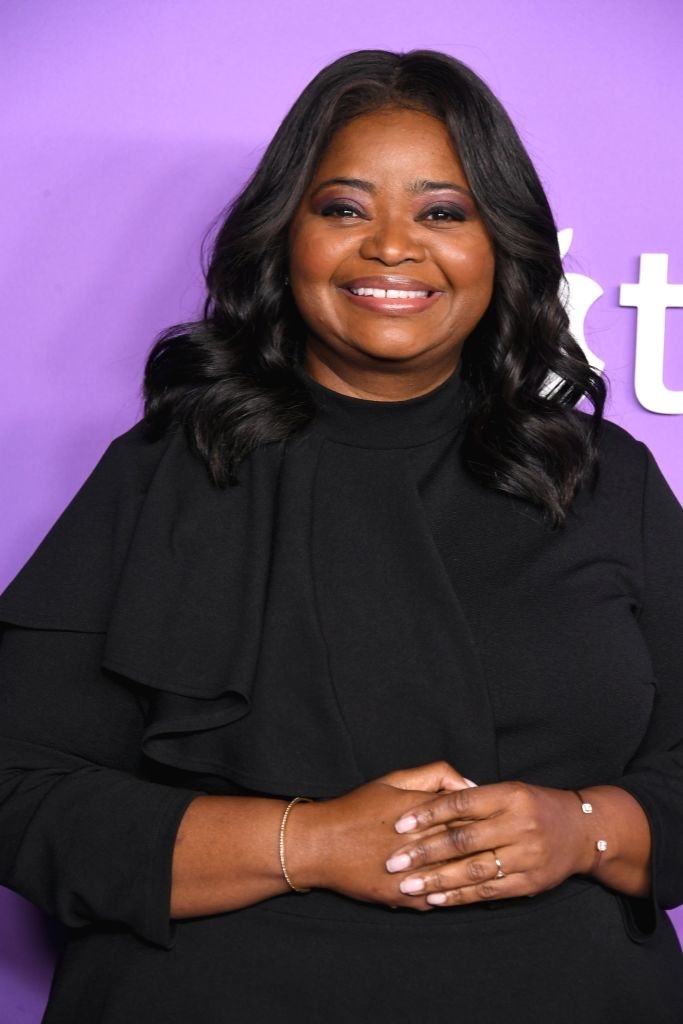 Octavia Spencer wearing a stylish top with her hair curled and worn loose