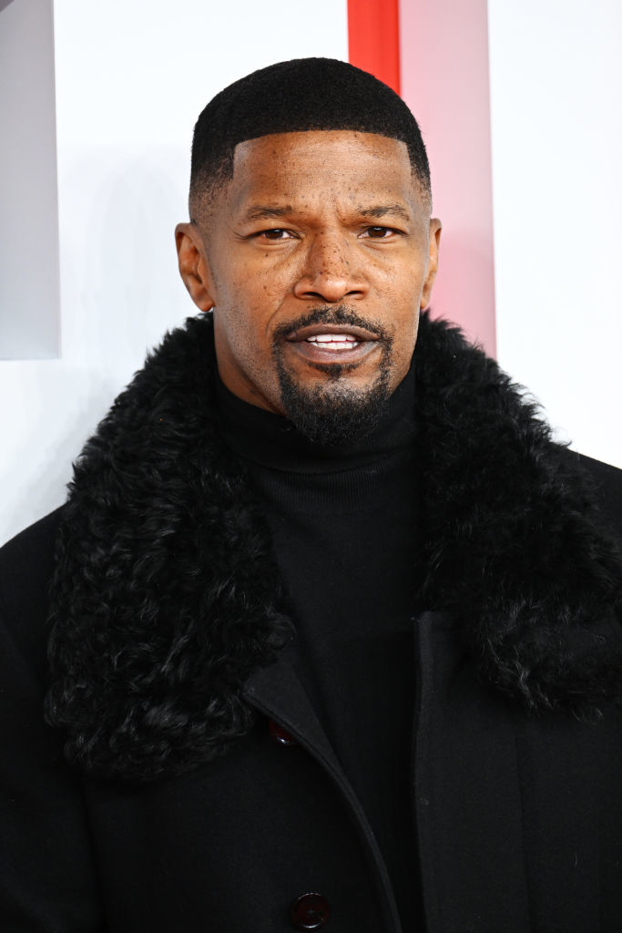 Jamie Foxx at an event wearing a coat with his hair cut short and a goatee
