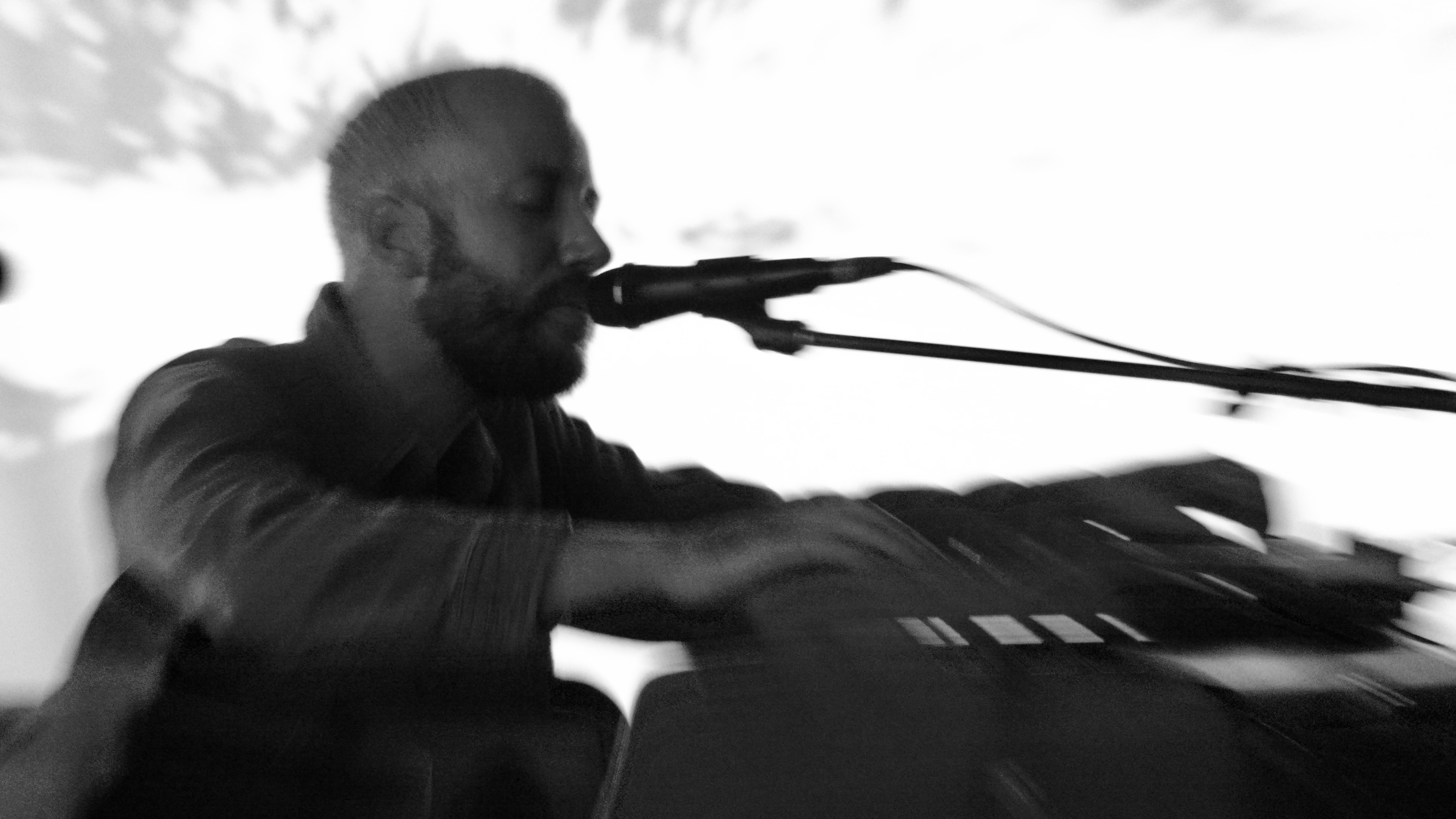 Musician in motion playing keyboard, blurred artistic effect captures dynamic performance