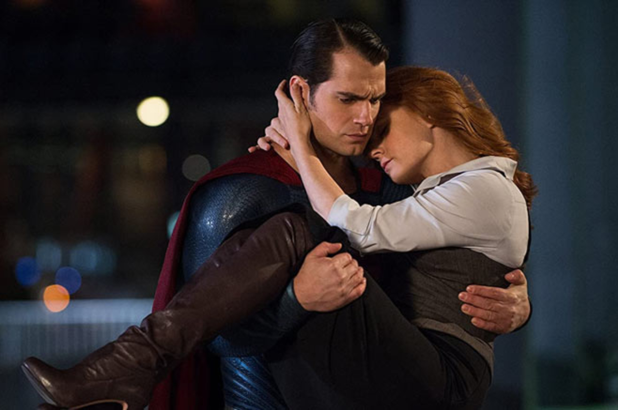 Superman holding Lois Lane in a comforting embrace at night