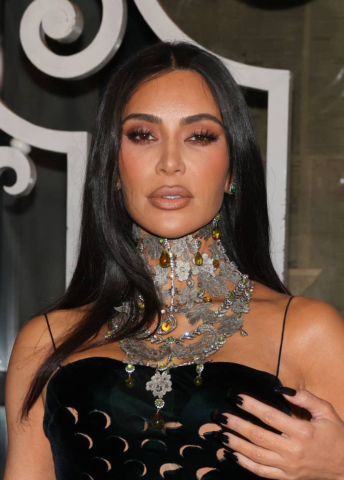 Kim Kardashian wearing a cut-out dress with a high-neck jeweled collar