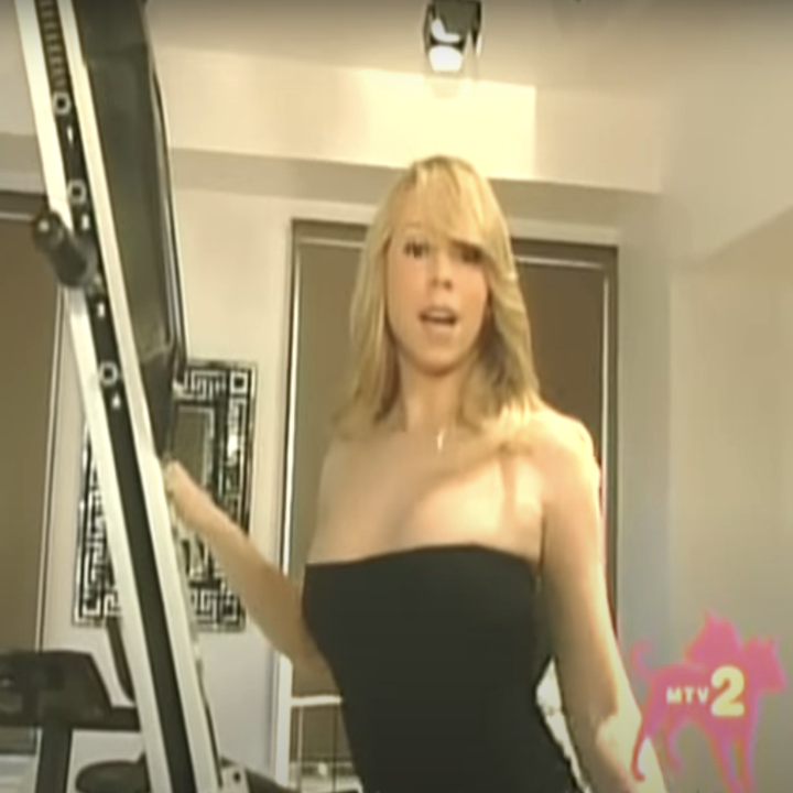 Mariah in a gym, using a stair climber machine