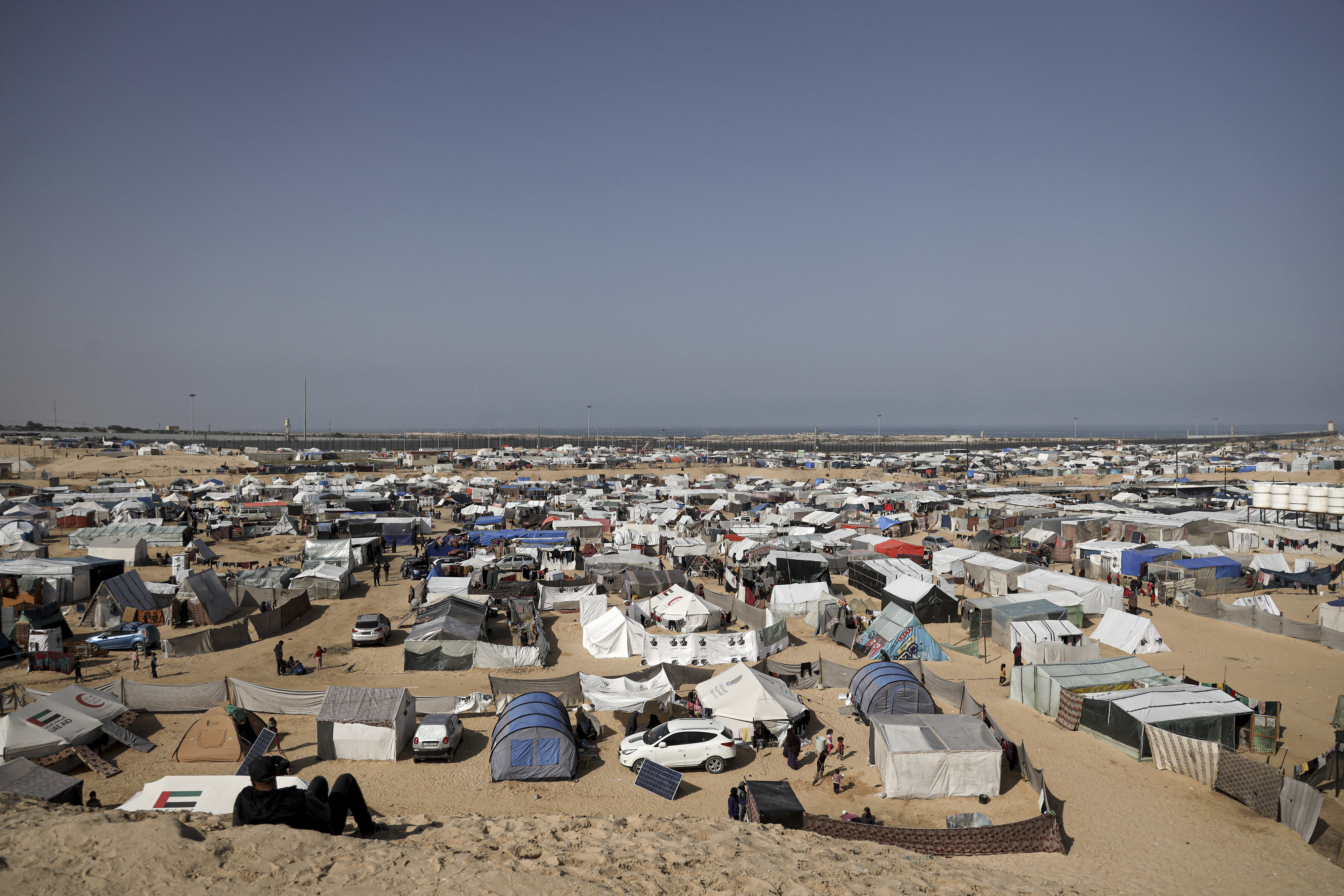 Sprawling refugee camp with tents pitched in a desert area