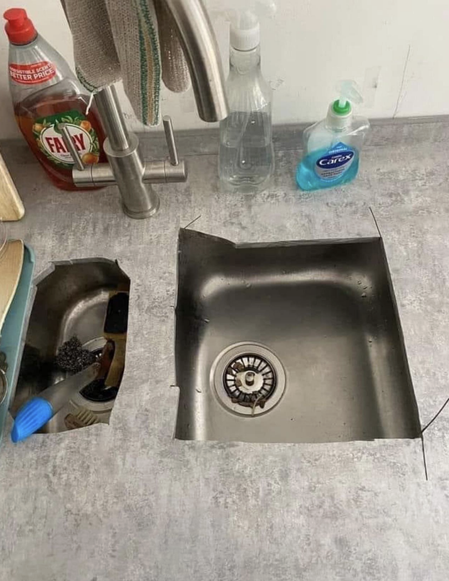 Kitchen sink with a raggedly cut-out area of the counter