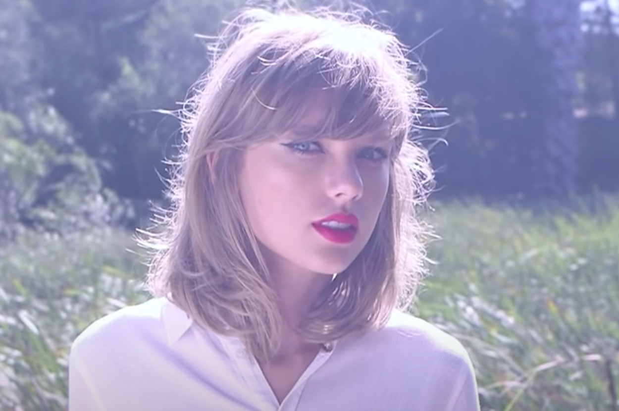 Taylor Swift in a sunny field in the Style music video