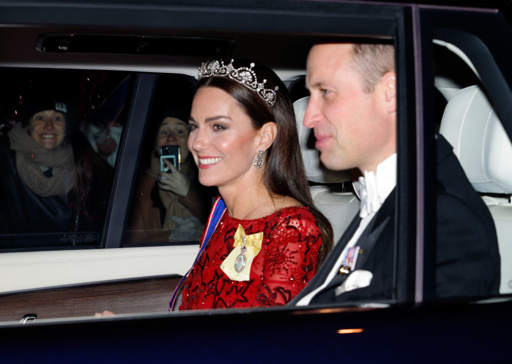 Closeup of Kate Middleton, wearing a tiara, and Prince William in a car