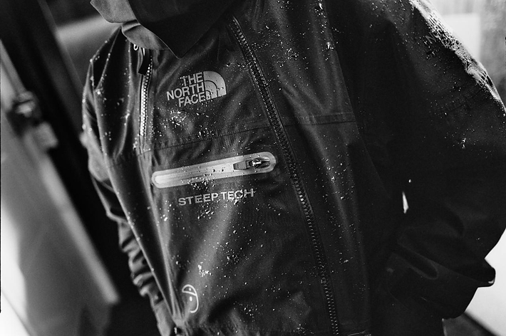 Close-up of a wet jacket with 'The North Face' and 'Steep Tech' logos