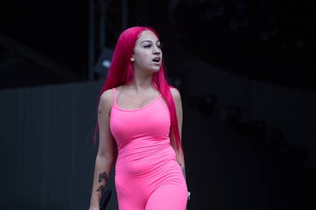 Bhad Bhabie performing on stage in a pink bodycon outfit