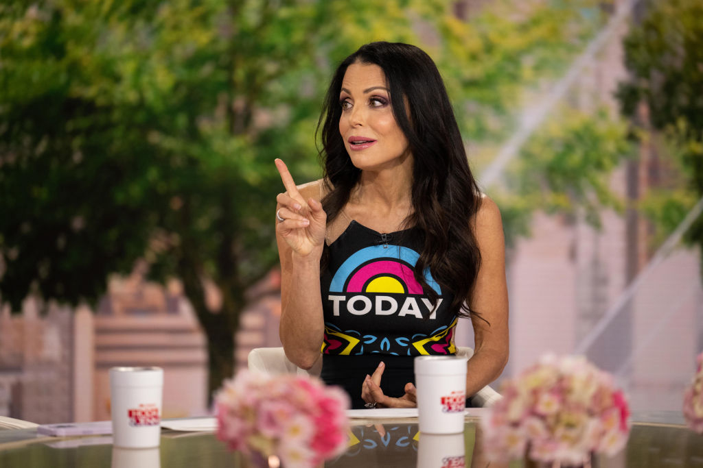 Bethenny Frankel gestures while wearing a &#x27;TODAY&#x27; show branded tank top, seated at a table with coffee cups