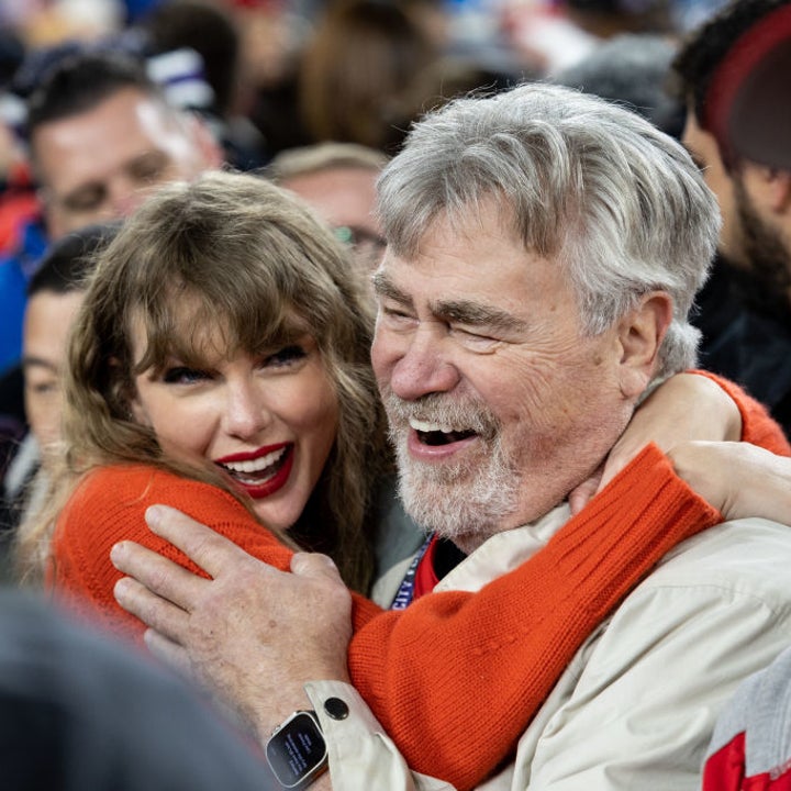 Taylor Swift and Travis' dad embracing in a crowd