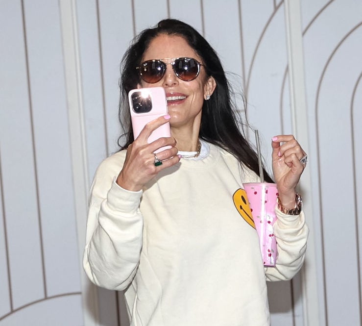bethenny talking a mirror selfie with holding a large water bottle