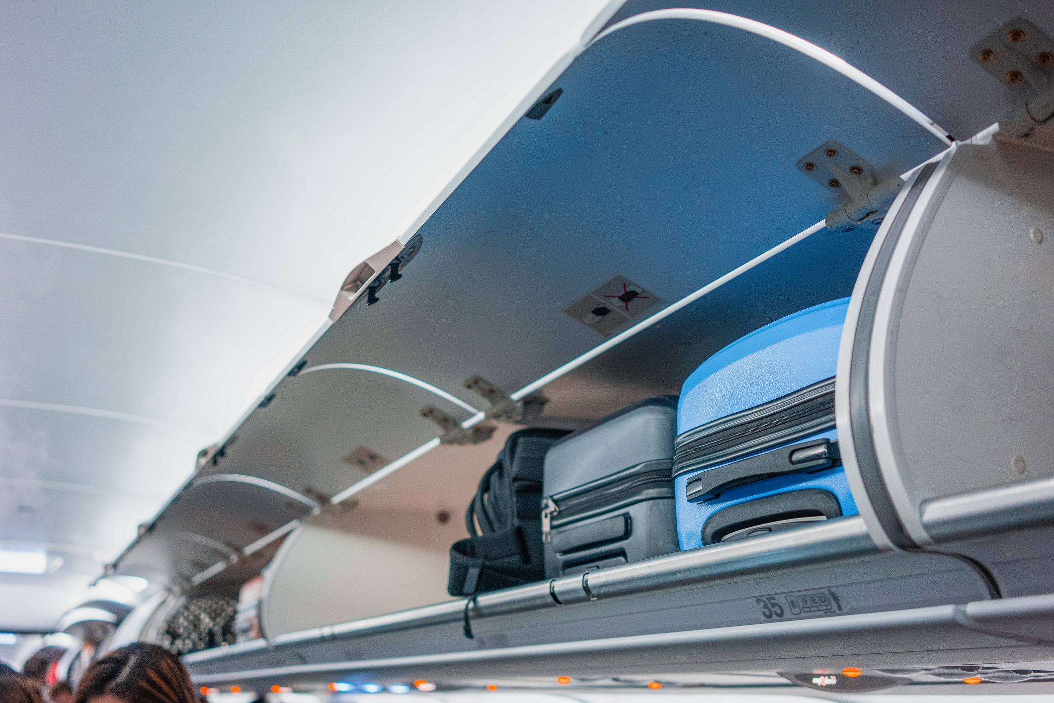 Luggage stored in overhead bins on an airplane