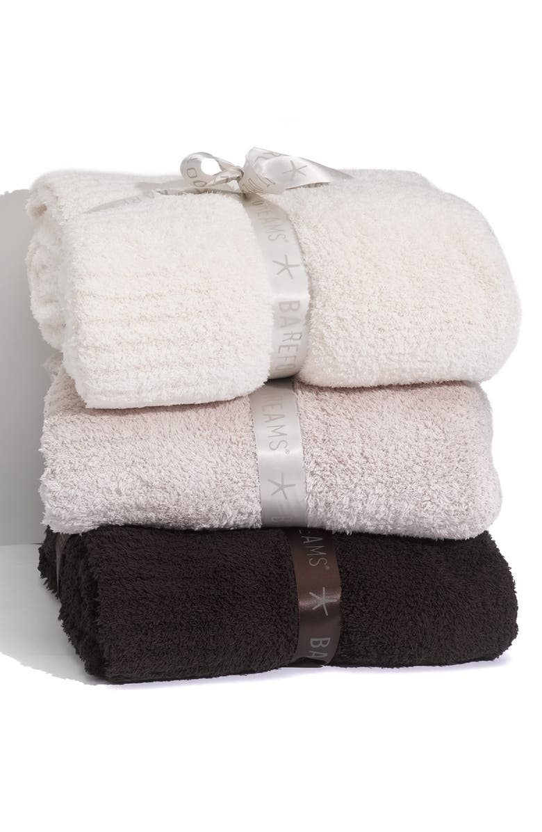 A stack of three plush blankets
