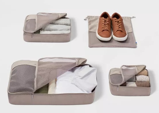 Four different sized packing cubes in taupe with clothes and a pair of shoes in them