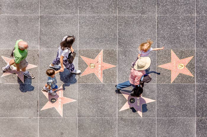 Aerial view of people walking among Hollywood Walk of Fame stars