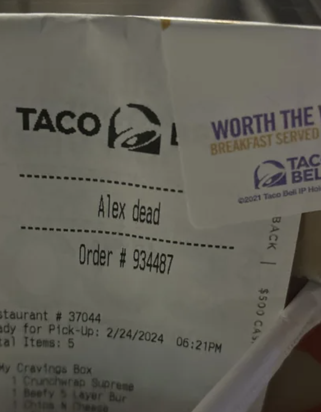 Receipt with a handwritten note saying &quot;Alex dead&quot; under the name section