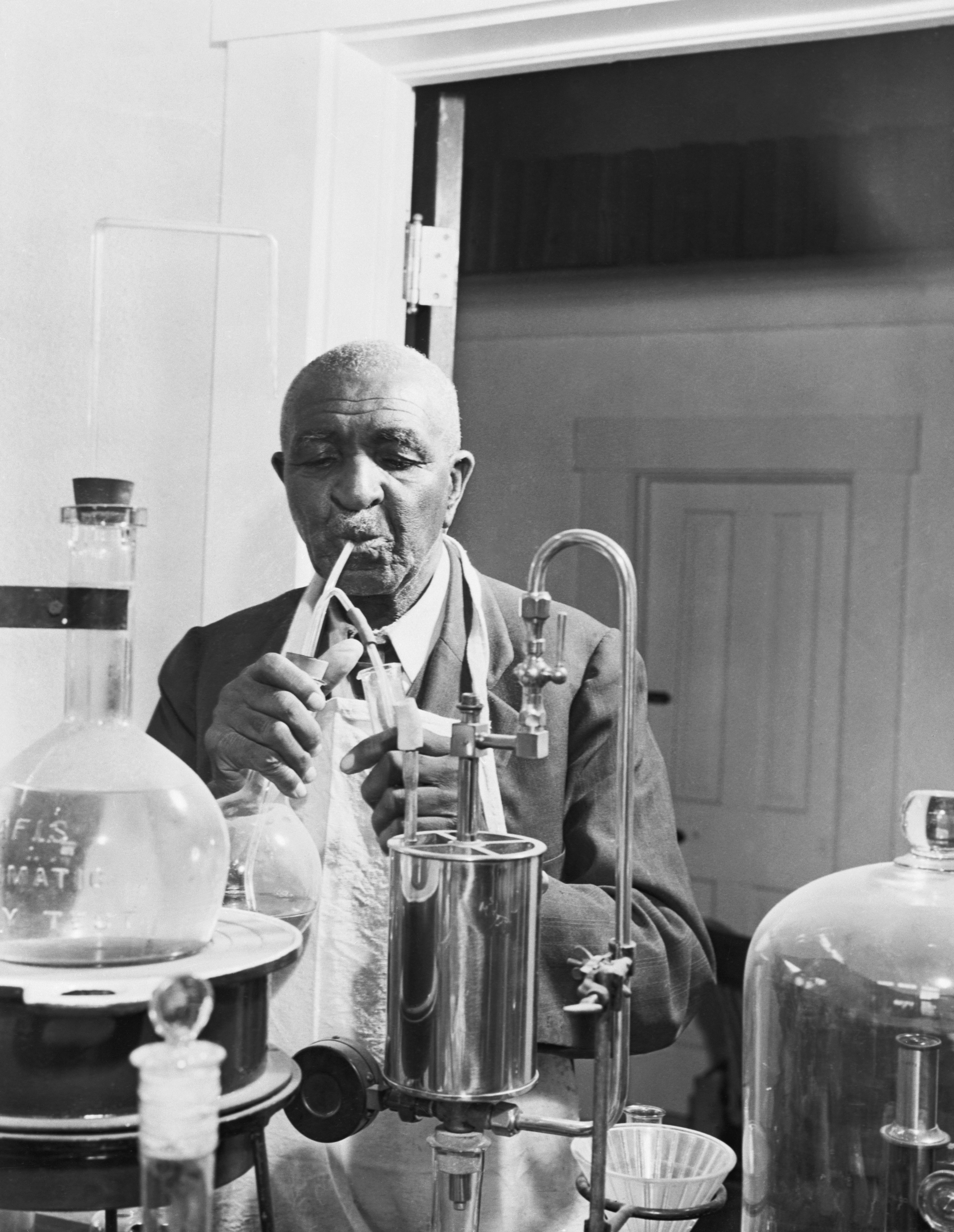 A man working with laboratory glassware and apparatus