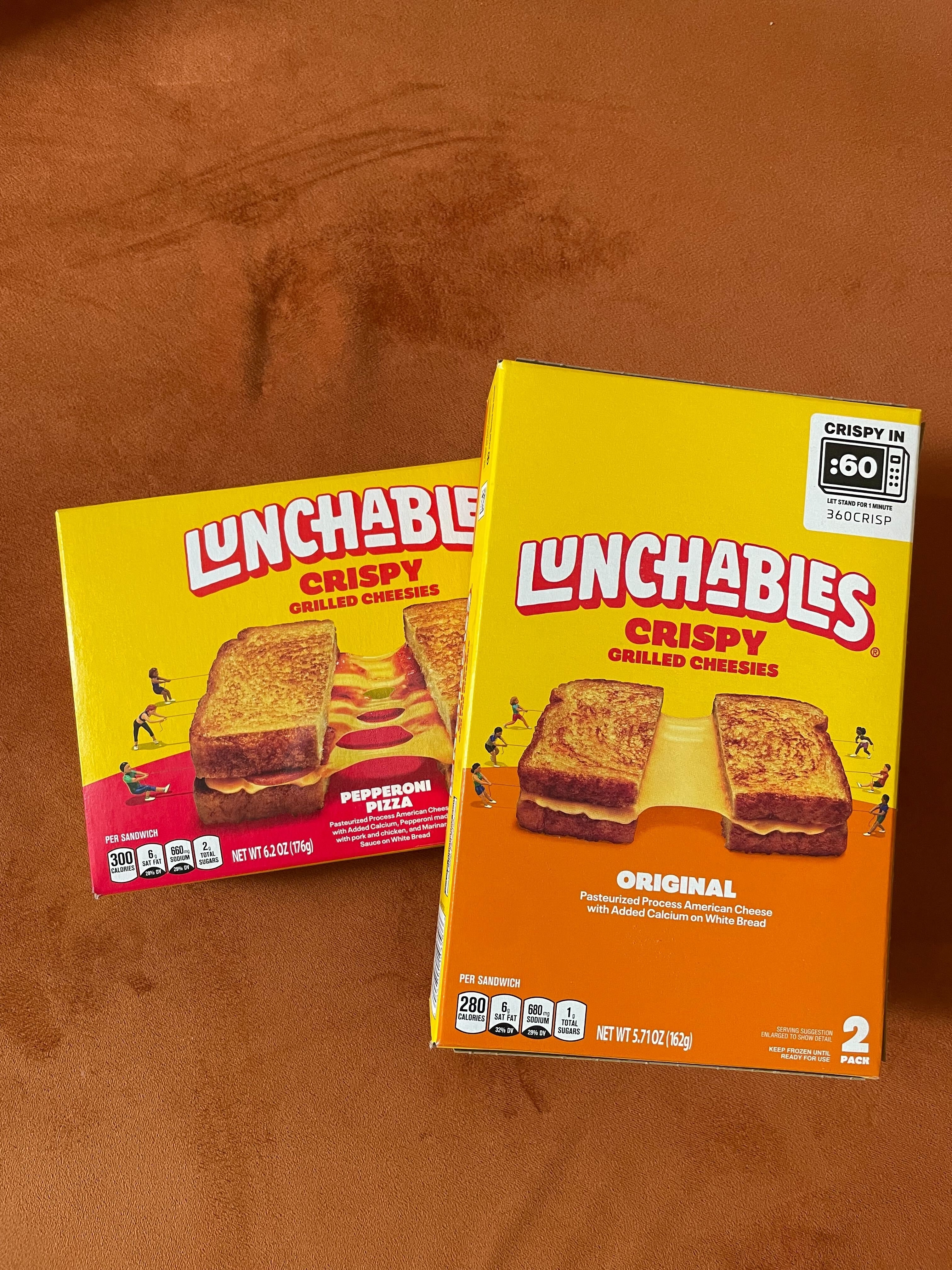 Two Lunchables Crispy Grilled Cheese kits on a table, one original and one pepperoni flavor