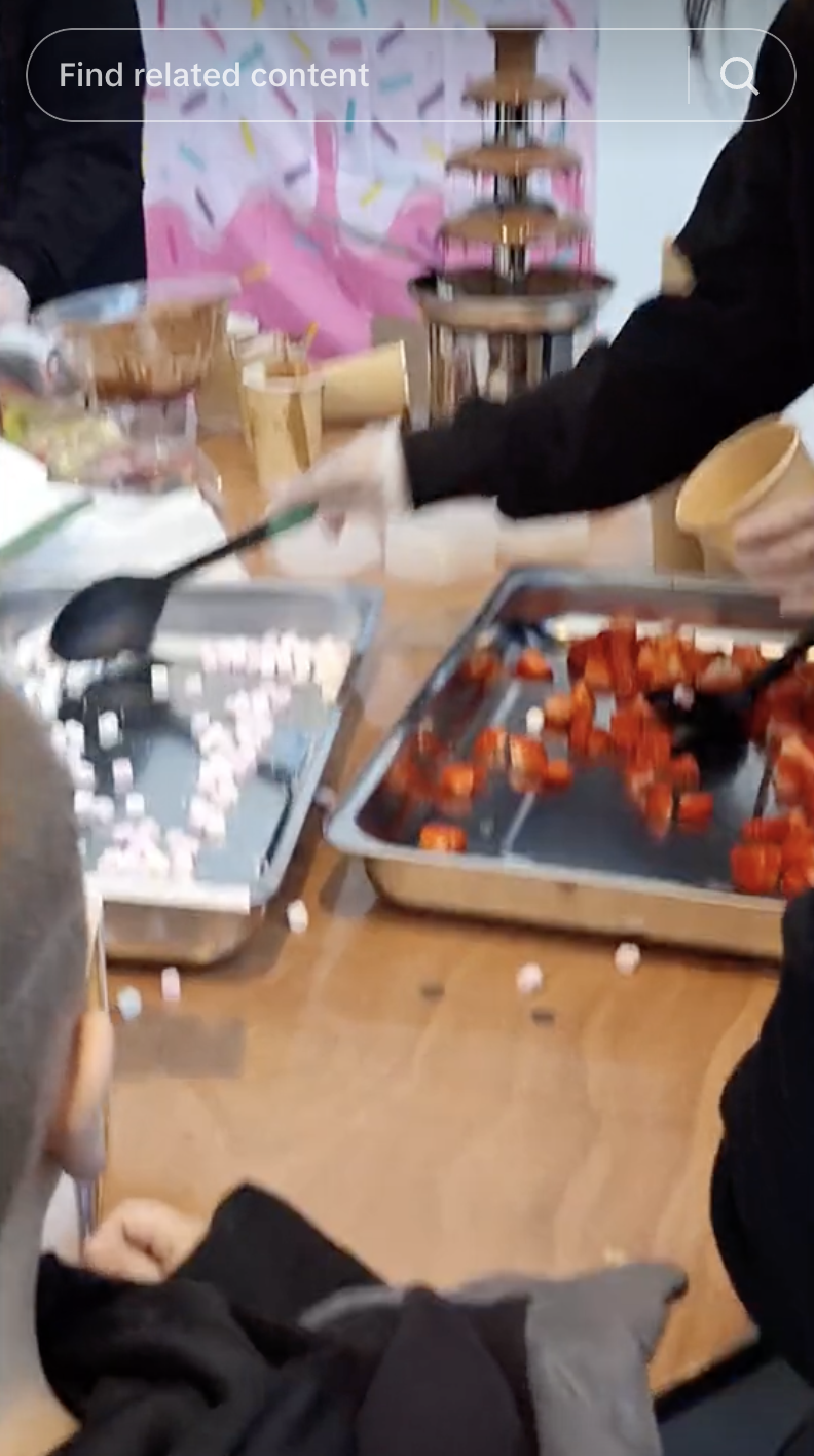 Blurry image of people around a table with candy and containers