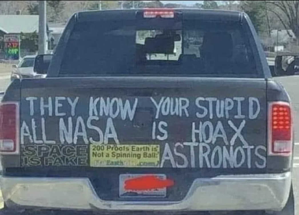 Truck with text dismissing NASA and promoting a flat Earth theory