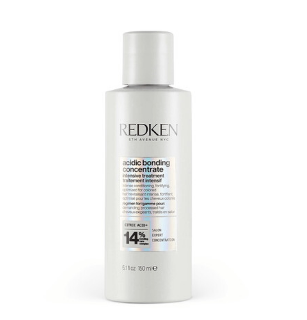 Redken hair treatment bottle labeled &quot;acidic bonding concentrate&quot; for intense repair