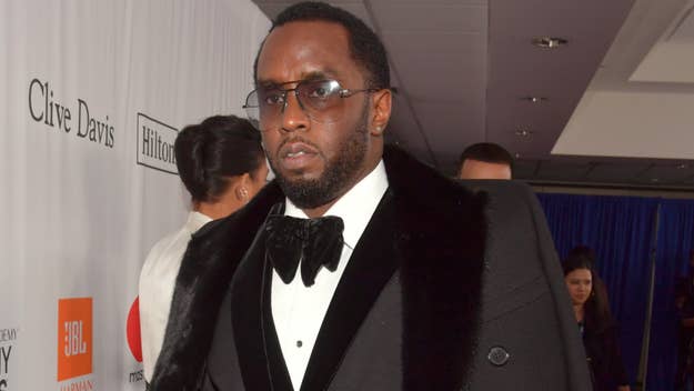 Sean Combs in a black tuxedo with a bow tie at a Clive Davis event