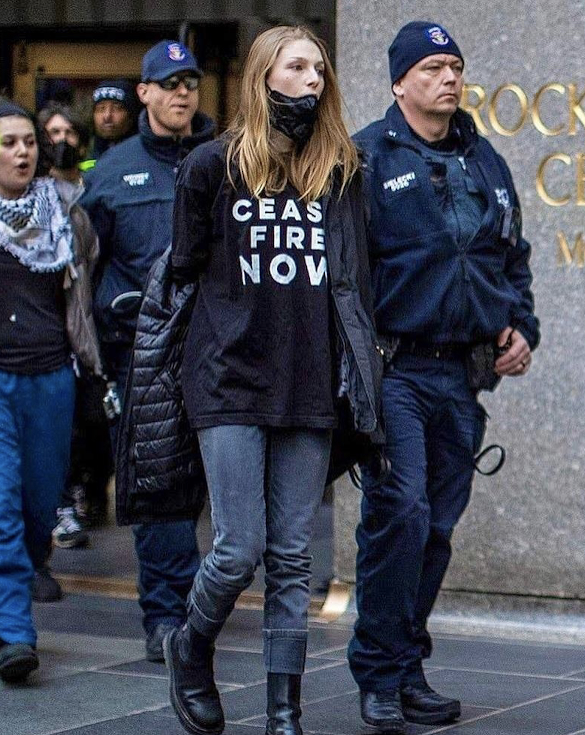 Hunter in protest with &#x27;CEASE FIRE NOW&#x27; shirt being escorted by police