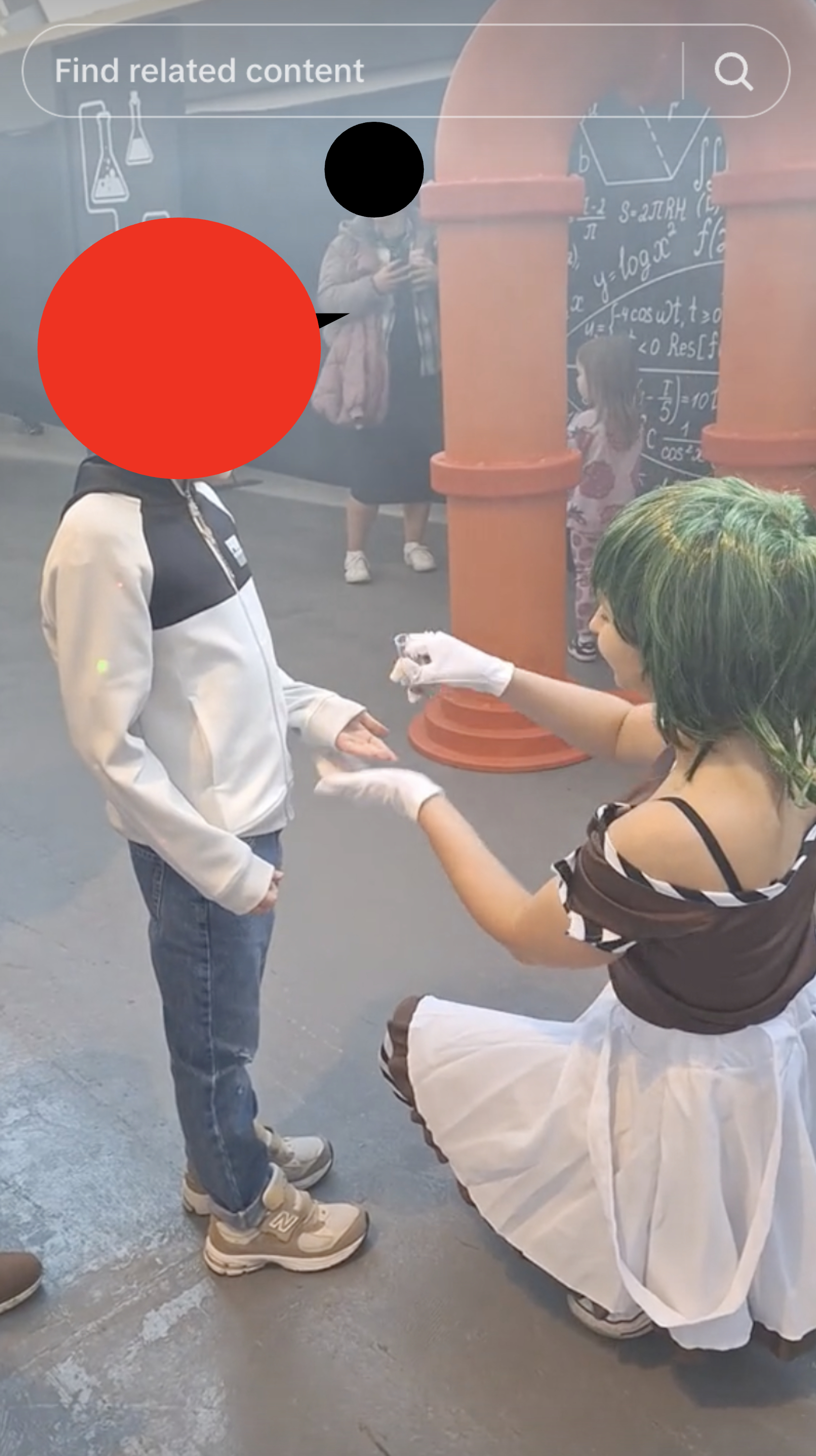 an oompa loompa kneeling and giving a child candy