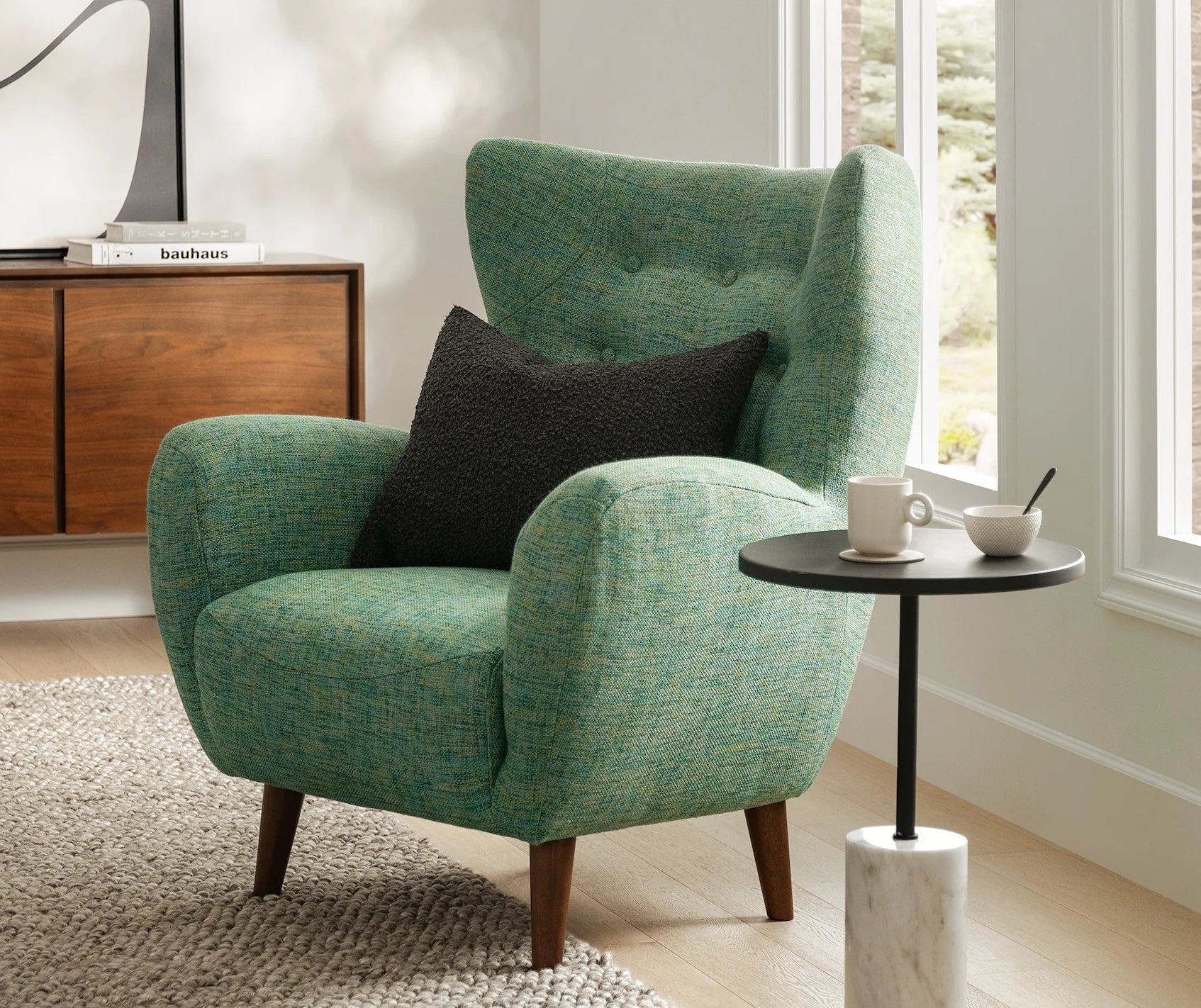 Textured armchair with a side table displaying a tea set in a well-lit, cozy room setup
