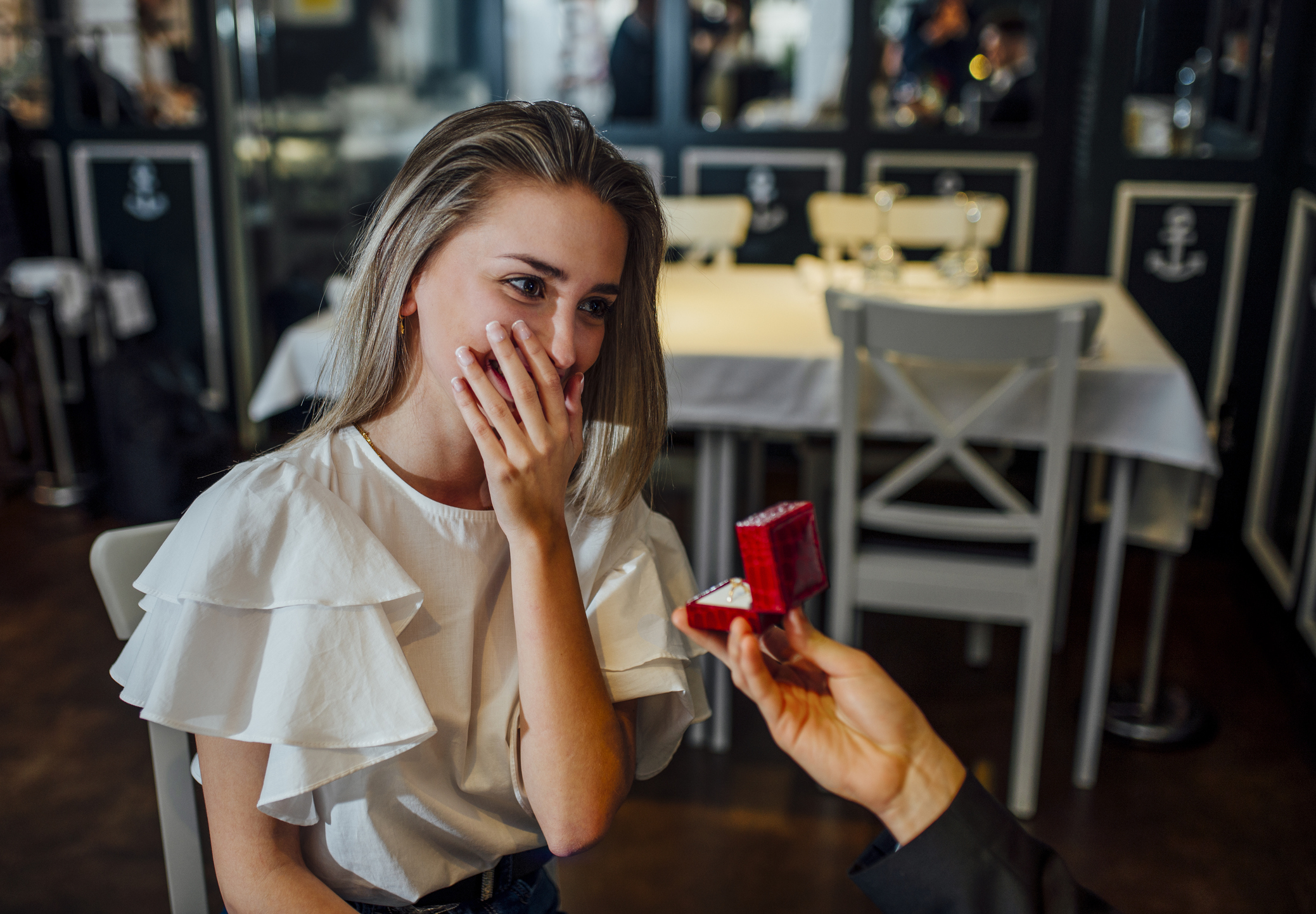 Woman getting proposed to at a restaurant