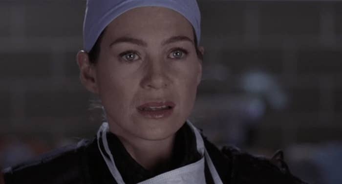 Ellen Pompeo as Meredith Grey in surgical cap, concerned expression on her face