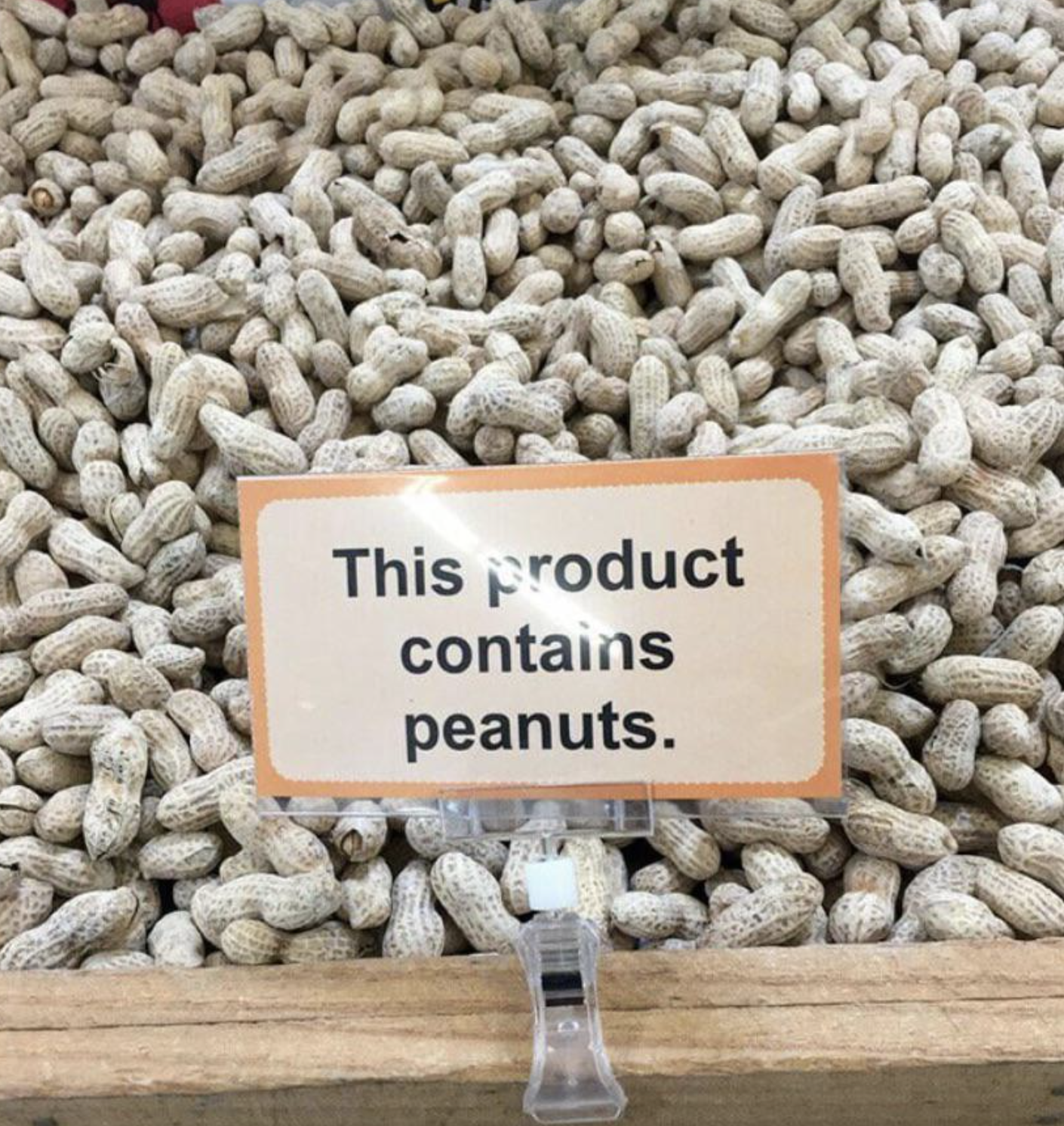 Sign on peanuts display reads &quot;This product contains peanuts.&quot;