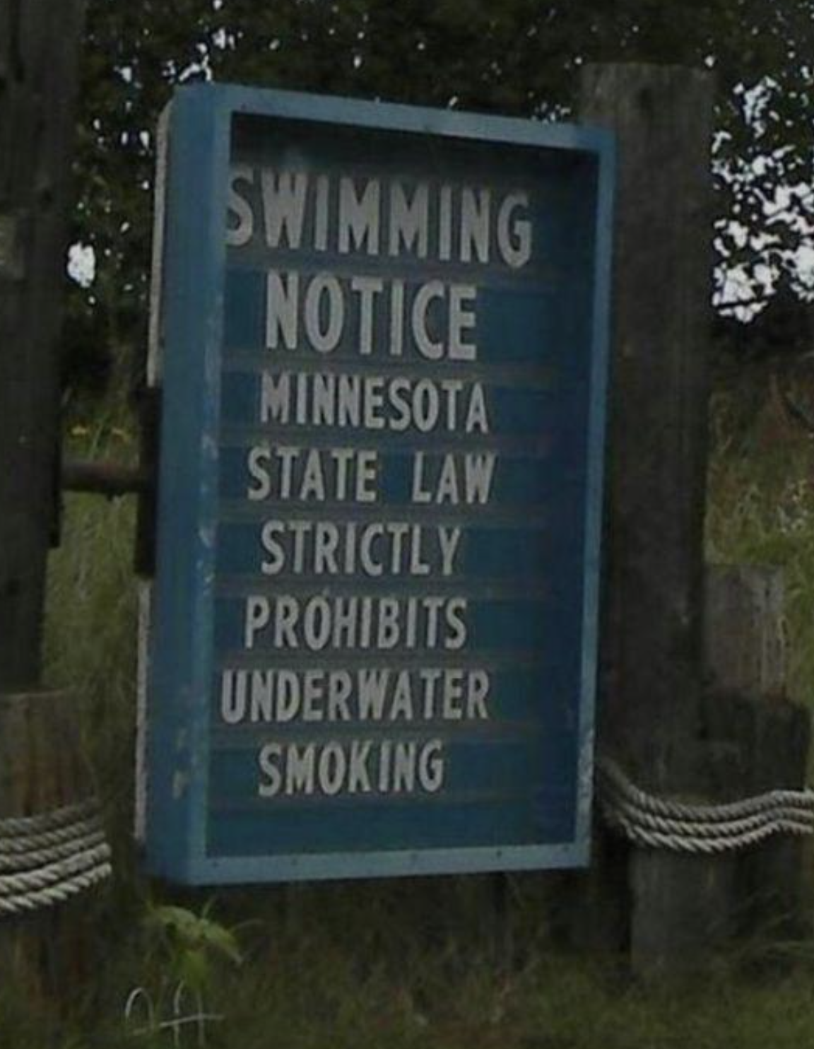 Sign reads &quot;Swimming Notice: Minnesota State Law strictly prohibits underwater smoking.&quot;