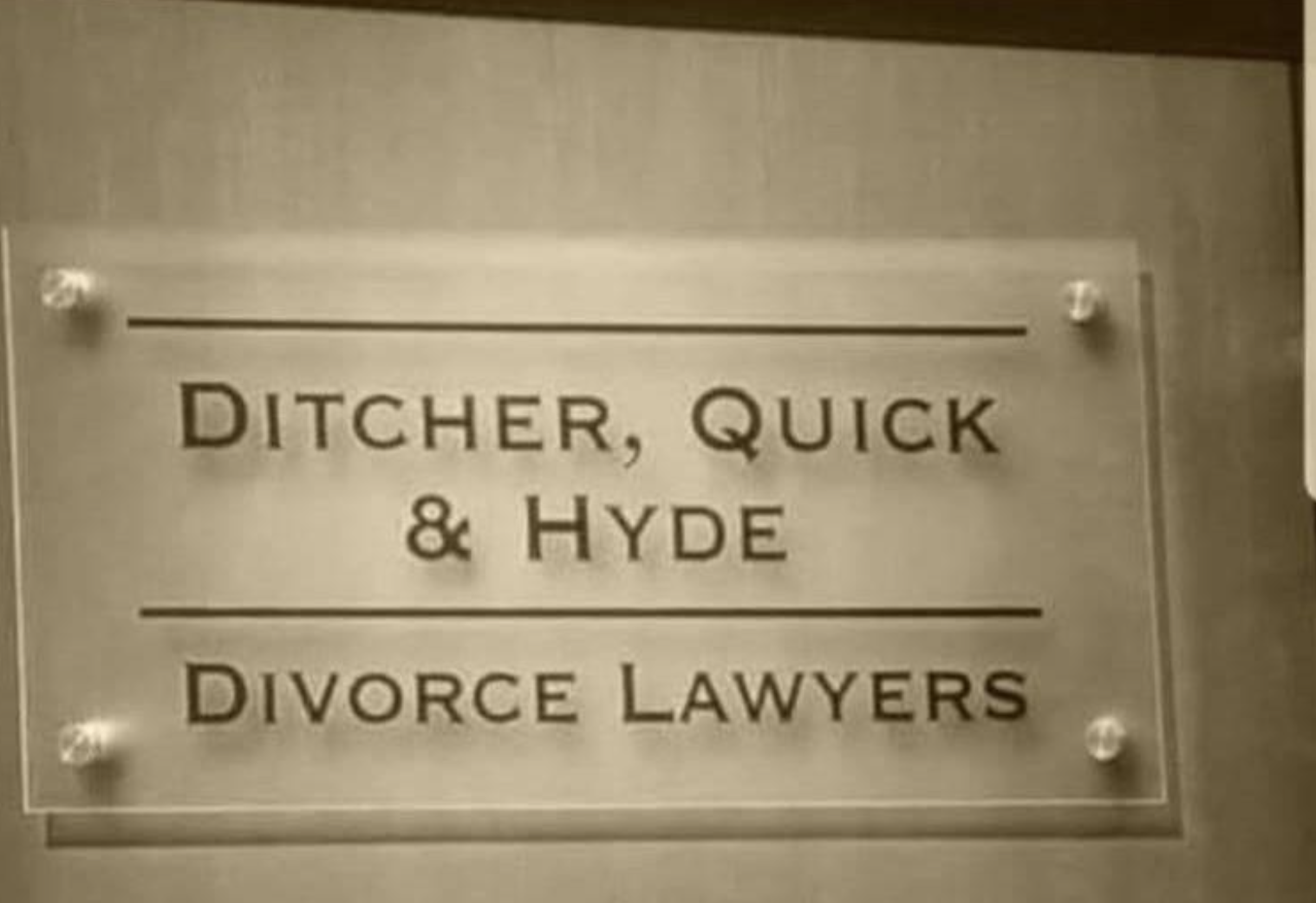 Sign on a wall reading &quot;Ditcher, Quick &amp;amp; Hyde Divorce Lawyers.&quot;