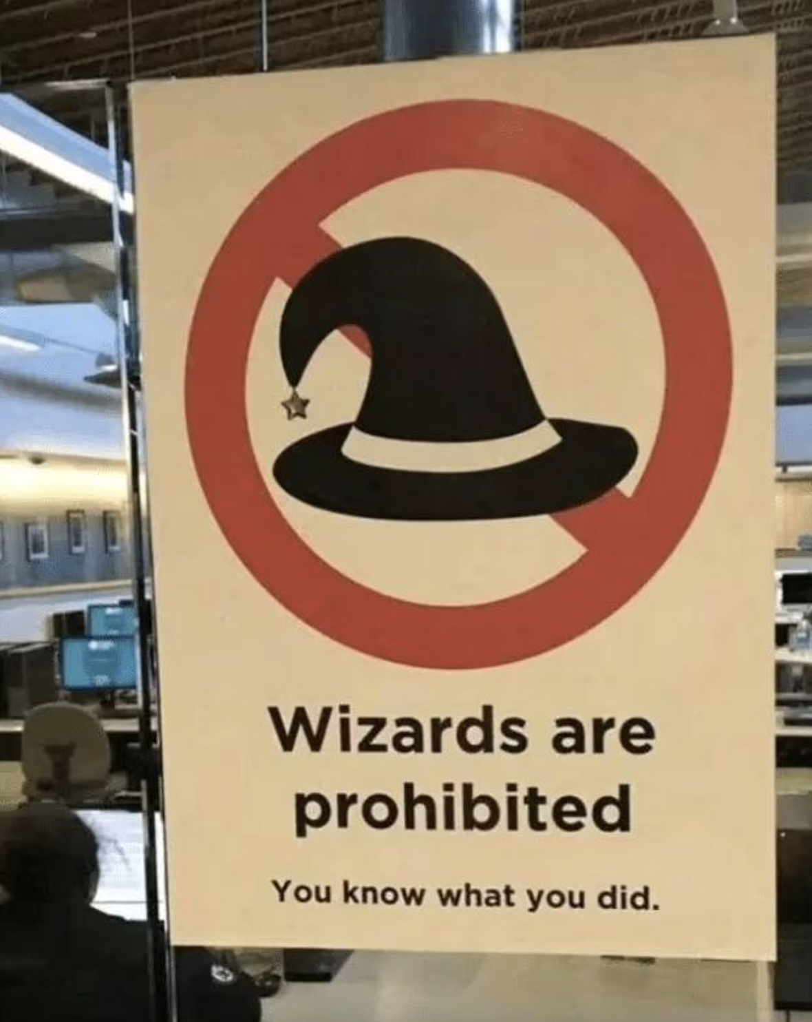 Sign saying &quot;Wizards are prohibited - You know what you did&quot; with a wizard hat in a prohibition circle