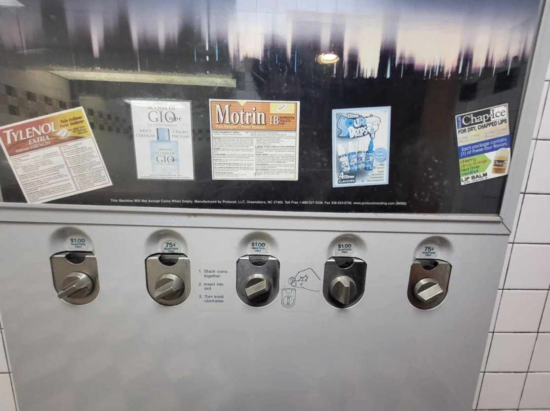 Vending machine dispensing medicine packets: Tylenol, Advil, Alka-Seltzer. Prices range from $0.75 to $1.50