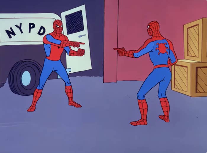 Two Spider-Man characters from an animated series are pointing at each other