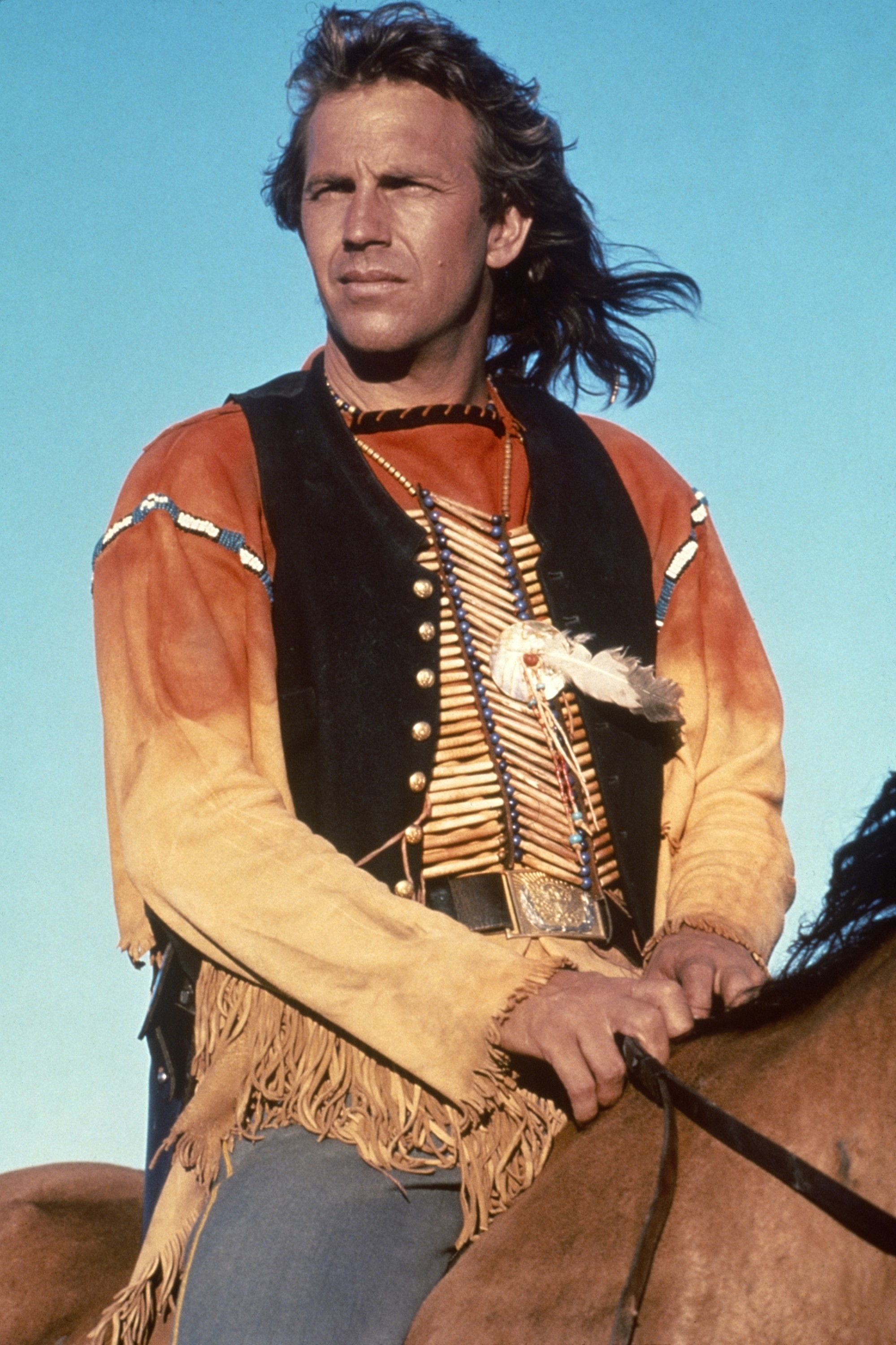 Kevin Costner as Dunbar in historical costume with fringed jacket on a horse, evoking classic Western films