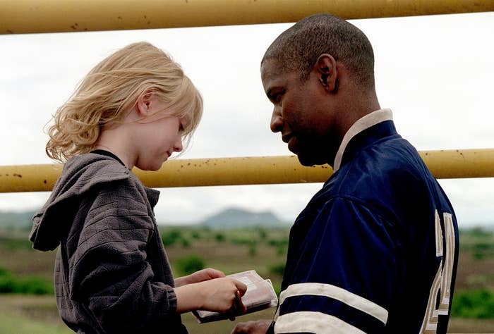 Dakota Fanning as a child and Denzel Washington look at one another