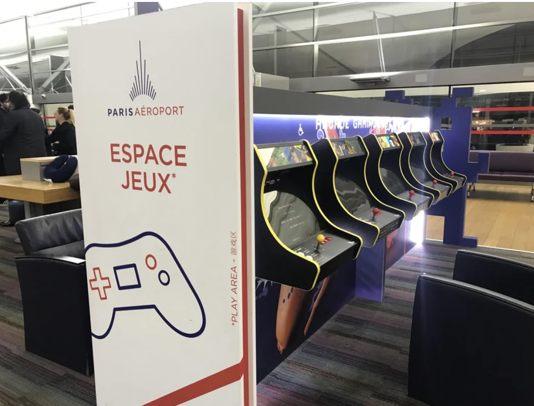 Arcade gaming area at Paris Airport with multiple video game machines