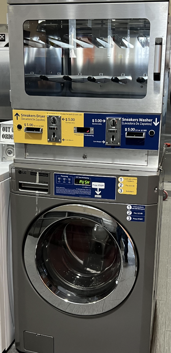 Front view of a specialized sneaker washer and dryer machine with pricing and instructions labels