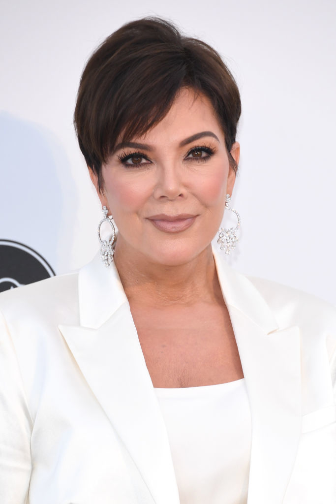 Kris Jenner in a blazer, with large earrings, attending an event