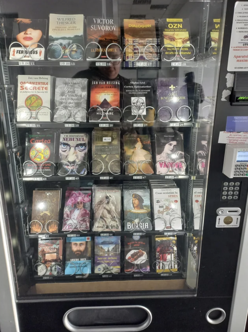 Book vending machine filled with various titles, including works by Victor Suvorov and Joe Navarro